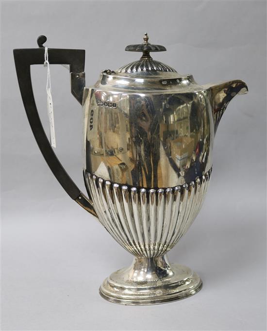 A George V demi-fluted silver hot water pot by Walker & Hall, Sheffield, 1917, gross 23 oz.